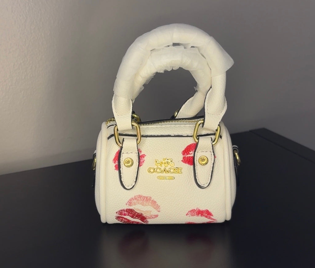 Coach mini handbag with gold chains.
