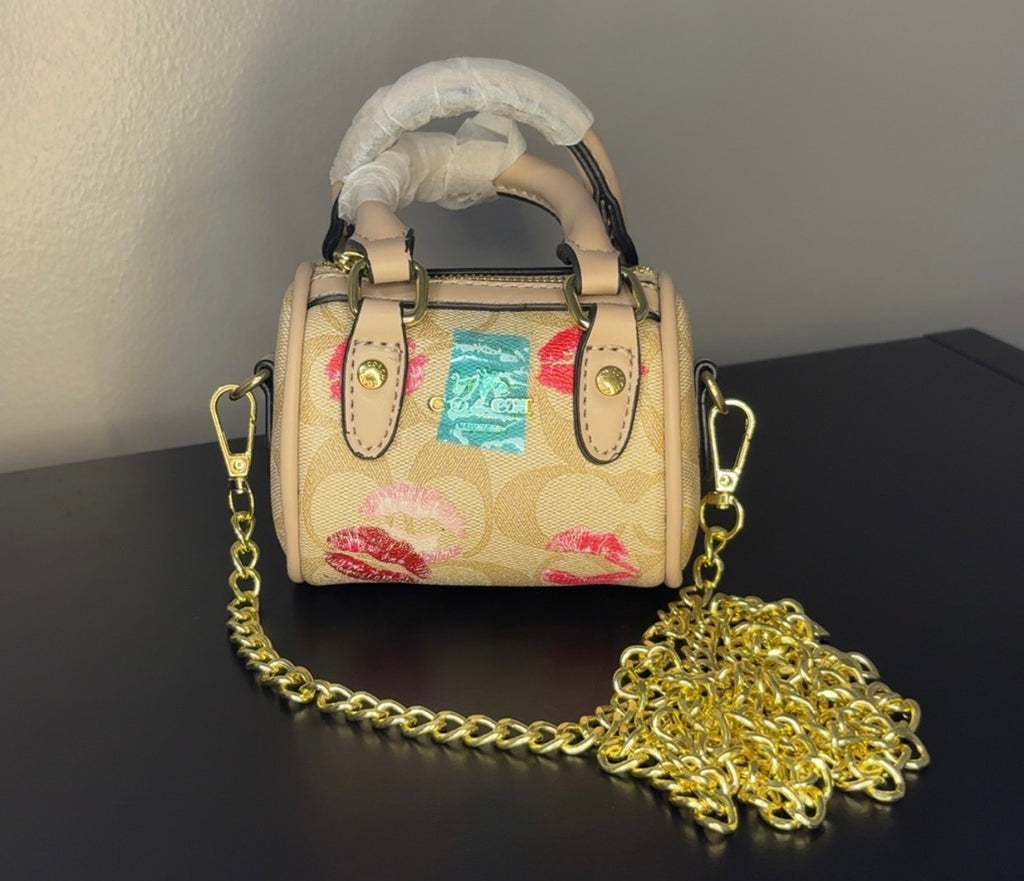 Coach mini handbag with gold chains.