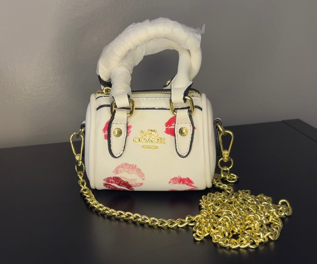 Coach mini handbag with gold chains.