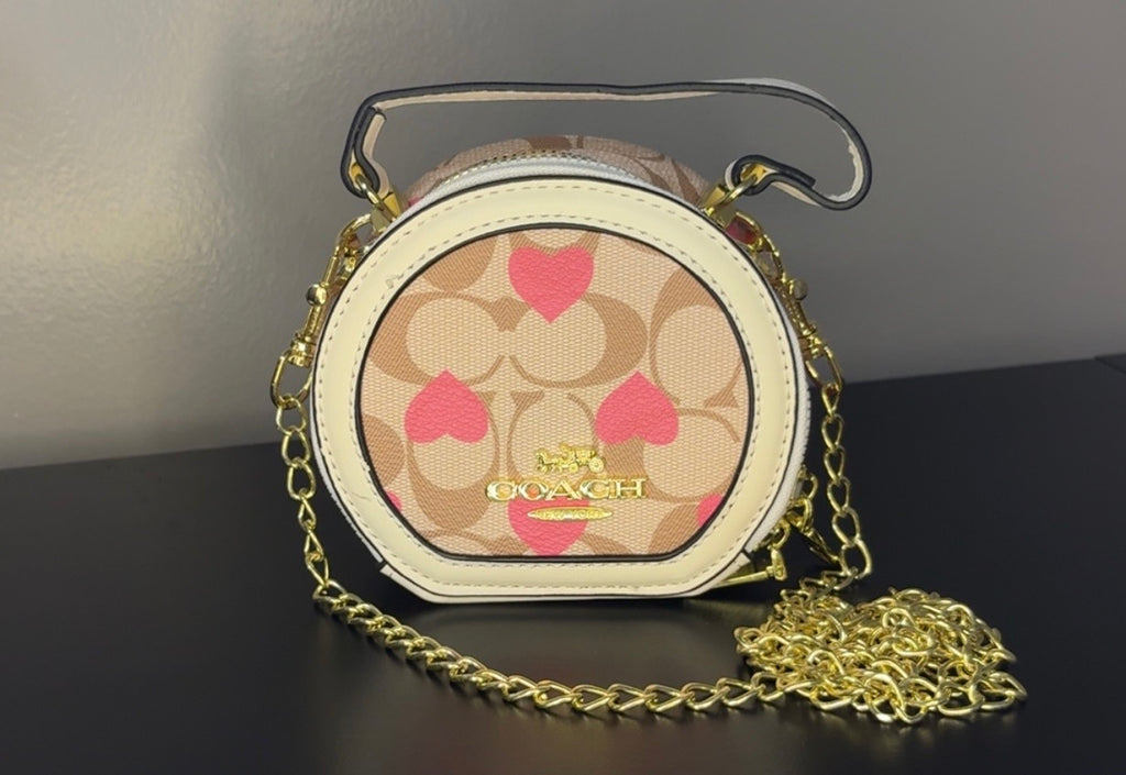 Coach Round Mini Crossbody bags. With pink heart. multiple colors. pink and red cherry.