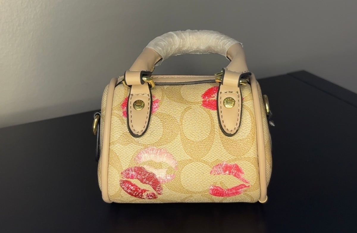 Coach mini handbag with gold chains.