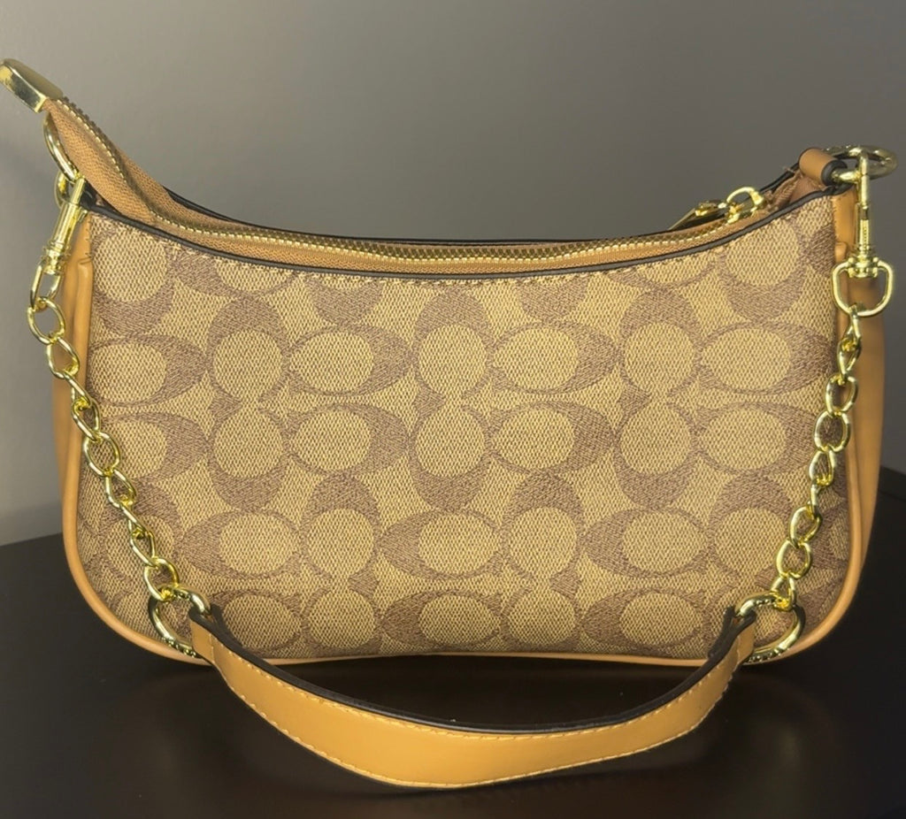 Coach crossbody bag with signature brown canvas.