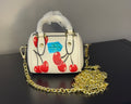 Coach mini handbag with gold chains.
