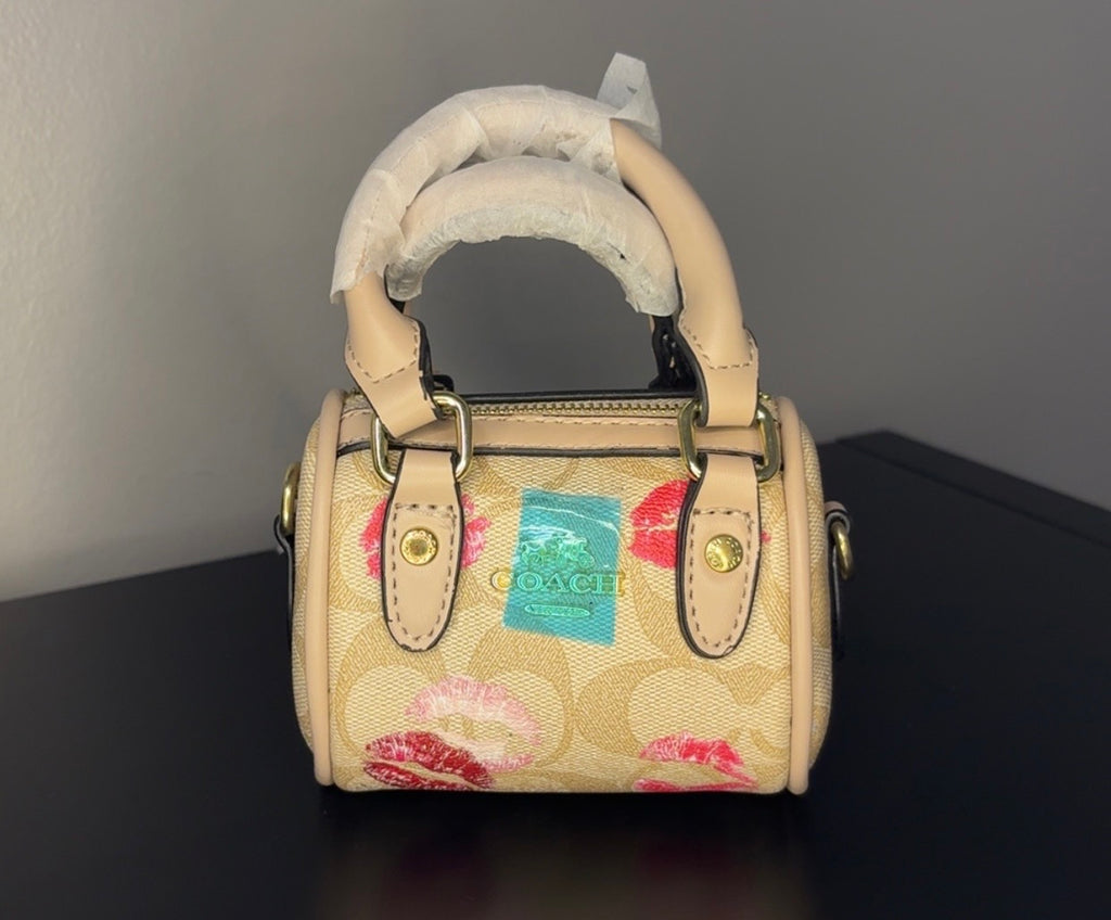 Coach mini handbag with gold chains.
