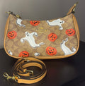 Coach crossbody bag with signature brown canvas.