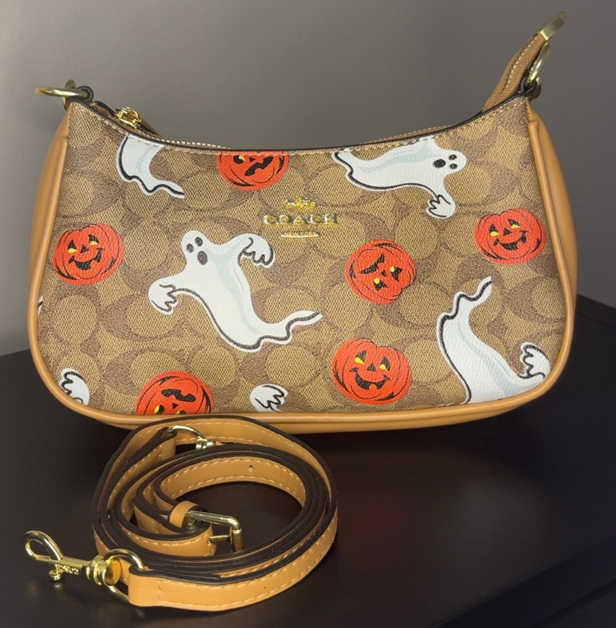 Coach crossbody bag with signature brown canvas.
