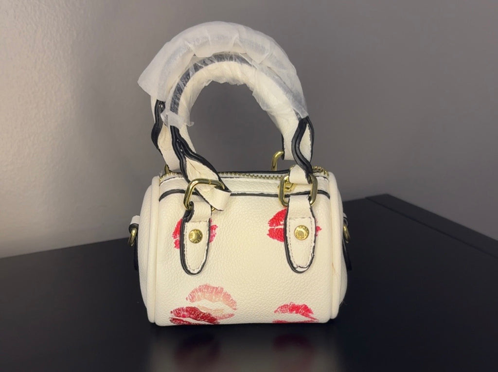 Coach mini handbag with gold chains.